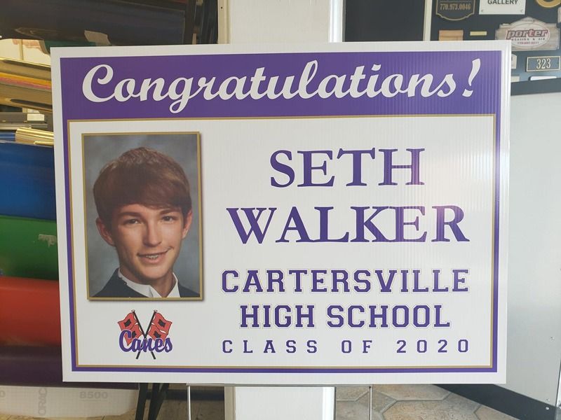 Graduation sign in purple lettering.